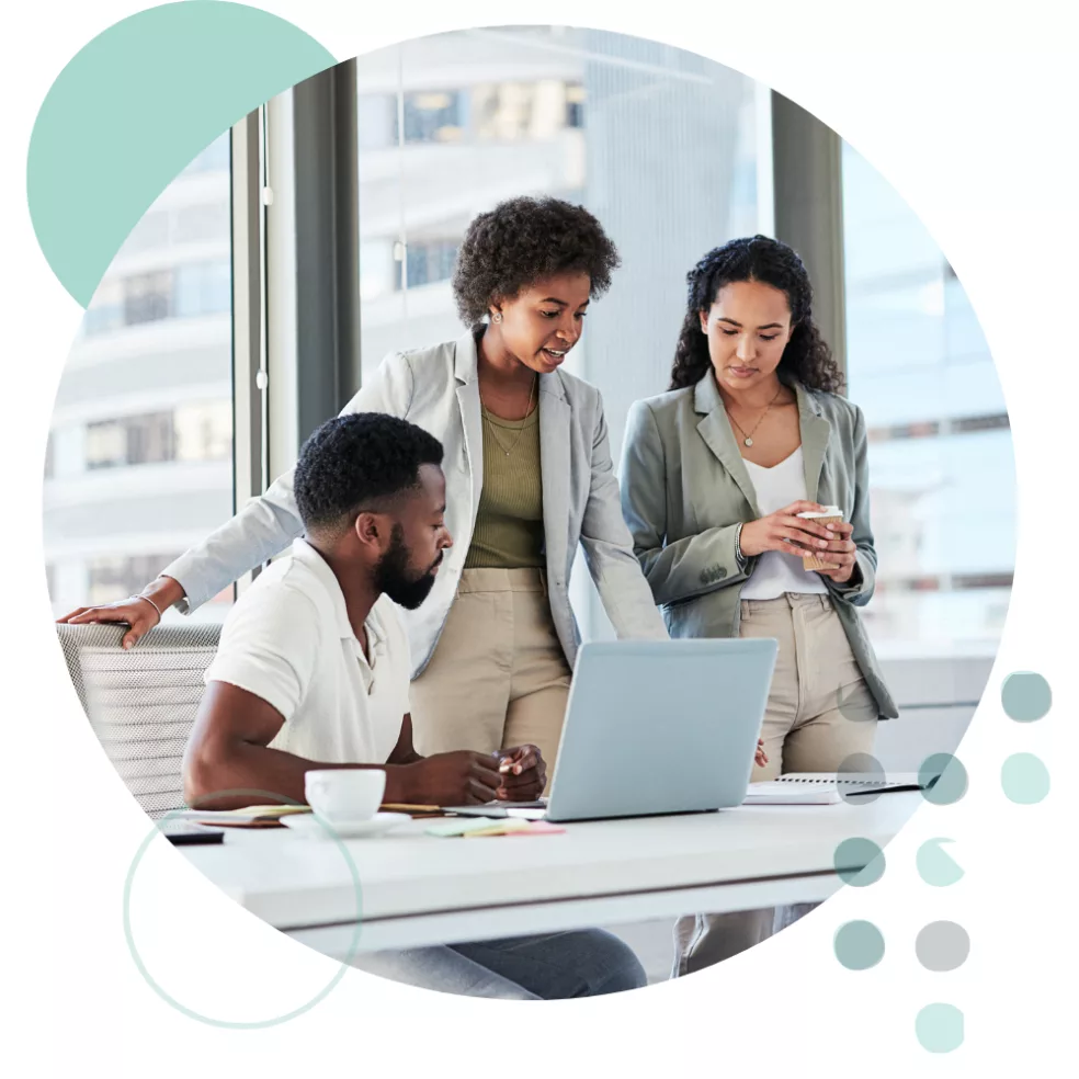 team-collaborating-around-laptop-in-modern-office