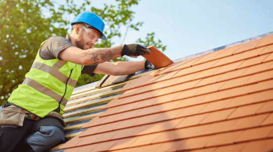 Roofer Nailing Orange Clay Tiles