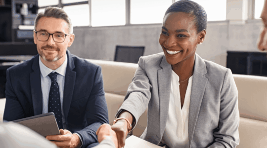 Business-people-shaking-hands-during-meeting.png